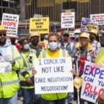 Diverse workers gathered during an ongoing strike for negotiations.