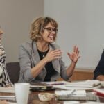 Group of women discussing leadership and media freedom.