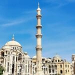 Restored Mosul monuments under clear blue skies.