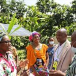 African leaders discussing sustainable energy solutions outdoors.