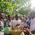 Diverse leaders discussing energy solutions under the African sun.