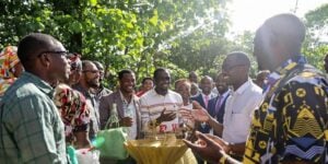 Diverse leaders discussing energy solutions under the African sun.