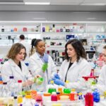 Diverse women scientists collaborating in a laboratory setting.