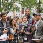 Diverse journalists celebrating at a university event.
