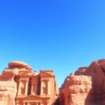 Petra's ancient rock-cut architecture against a clear sky.
