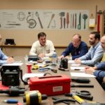 Unifor delegates discussing skilled trades at a meeting.