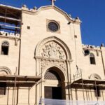 Restored Al-Tahera Church with scaffolding and historic architecture.