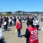 Coastal community preparing for tsunami with emergency drills.
