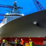 Naval ship under construction at a shipyard.