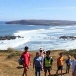 Community participating in tsunami preparedness activities along coast.