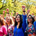 Diverse women rallying together for women's health awareness.