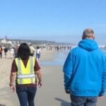 Community evacuation drill on the beach for tsunami preparedness.