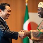 Japanese and Nigerian officials shaking hands.