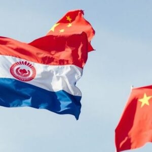 Uzbekistan and China flags waving together.