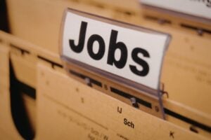 Close-up of a filing cabinet drawer with a white sign reading 'Jobs'.