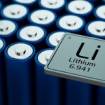 Close-up of blue cylindrical lithium battery cells with a square Li tile showing the element symbol and atomic number 3