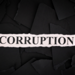 Pink torn paper strip with the word 'CORRUPTION' on a dark, torn-paper background.