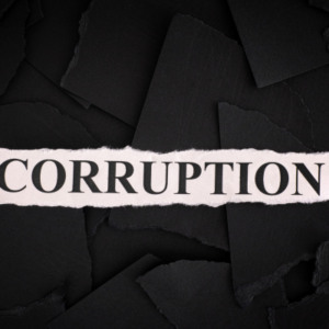 Pink torn paper strip with the word 'CORRUPTION' on a dark, torn-paper background.