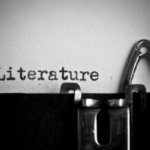 Close-up of a vintage typewriter typing the word 'Literature' on paper.