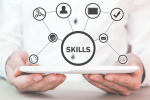 Tablet with a central circle labeled SKILLS connected to icons, representing skill development and networking.