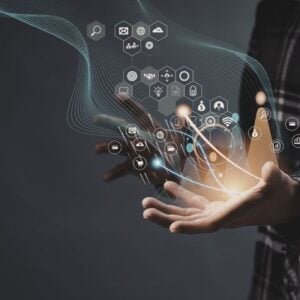 Hands releasing glowing holographic icons and network symbols, illustrating digital technology and connectivity.
