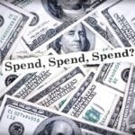 Pile of US $100 bills with a banner reading 'Spend, Spend, Spend?'.